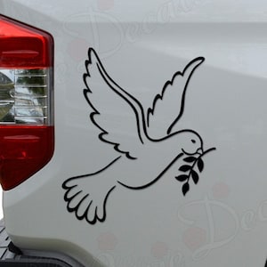 May include: Black outline of a dove carrying an olive branch, applied to the side of a white vehicle. The dove is depicted in flight, with its wings spread. The image is a decal, likely for a car or truck.