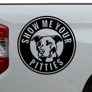 May include: Black and white decal sticker of a pit bull dog with the text "Show Me Your Pitties" in a circle on the back of a white pickup truck.