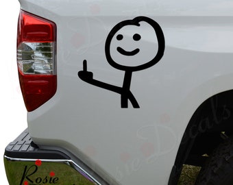May include: Black stick figure decal with a smiling face and raised middle finger. The decal is applied to the side of a white vehicle. The decal is a humorous design.