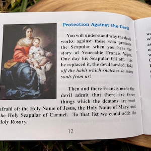May include: A painting of the Virgin Mary holding a young child. The Virgin Mary is wearing a blue robe with a red shawl. The child is wearing a white robe. The painting is set against a dark background. The text "Protection Against the Devil" is visible in the upper right corner of the image.