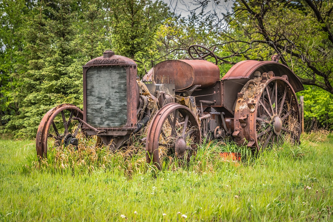 Old Vintage Farm Tractor Rusting Away in A Lush Green Field ...