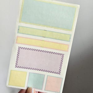 May include: A white ceramic mug with a black handle and the text "But First, Coffee" in a bold, black font. The mug is set against a neutral background, highlighting its simple design.