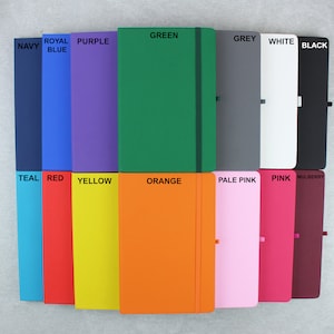 May include: A set of 14 notebooks in various colors, including navy, royal blue, purple, green, grey, white, black, teal, red, yellow, orange, pale pink, pink, and mulberry.