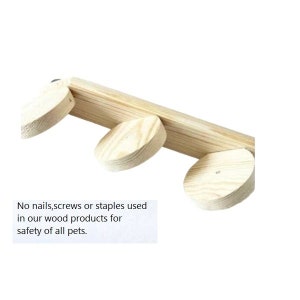 May include: A wooden pet product featuring a rectangular beam and three circular wooden platforms. The image text reads: "No nails, screws or staples used in our wood products for safety of all pets."