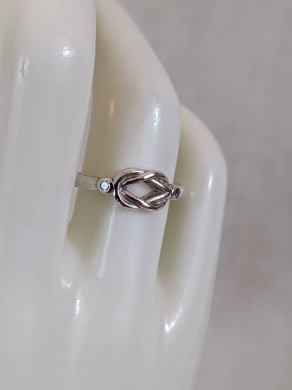 Genuine natural diamond and sterling silver "love knot" ring