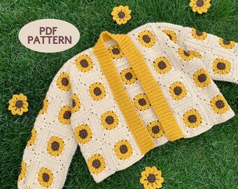 May include: A crocheted cardigan with a sunflower pattern in cream and yellow. The cardigan has a long, open front and is made with a textured stitch. The text "PDF PATTERN" is visible in the top left corner of the image.