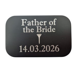 May include: A black rectangular plaque with rounded corners. The text "Father of the Bride" is at the top, with a golf tee symbol below it. The date "14.03.2026" is at the bottom, all in white.