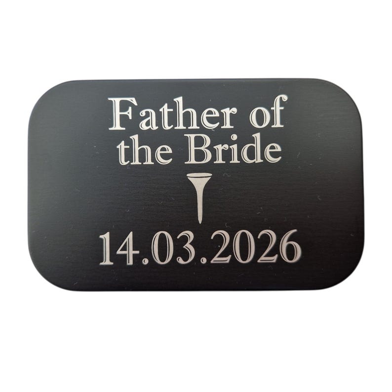 May include: A black rectangular plaque with rounded corners. The text "Father of the Bride" is at the top, with a golf tee symbol below it. The date "14.03.2026" is at the bottom, all in white.
