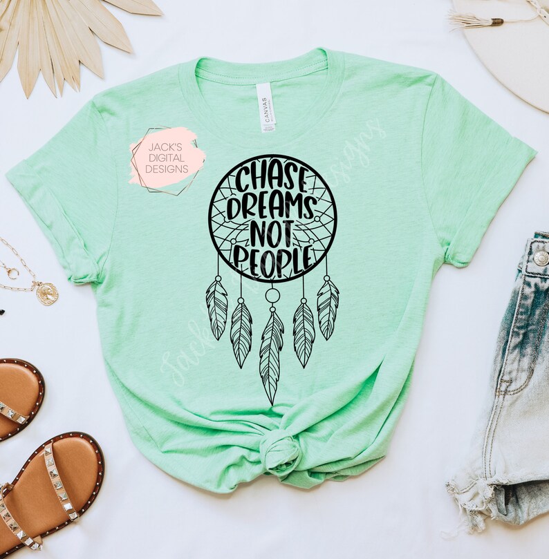 May include: A light green t-shirt with a black dreamcatcher design and the text "Chase Dreams Not People".