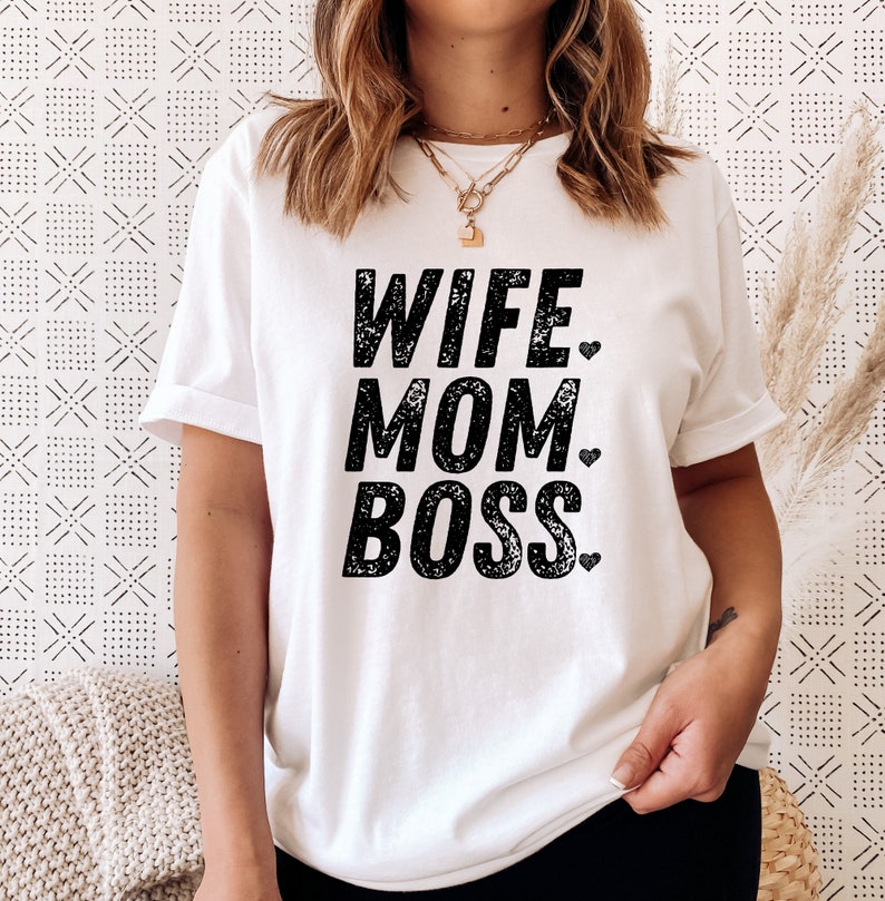 May include: White t-shirt with black text that reads "Wife Mom Boss" with a small heart after each word.