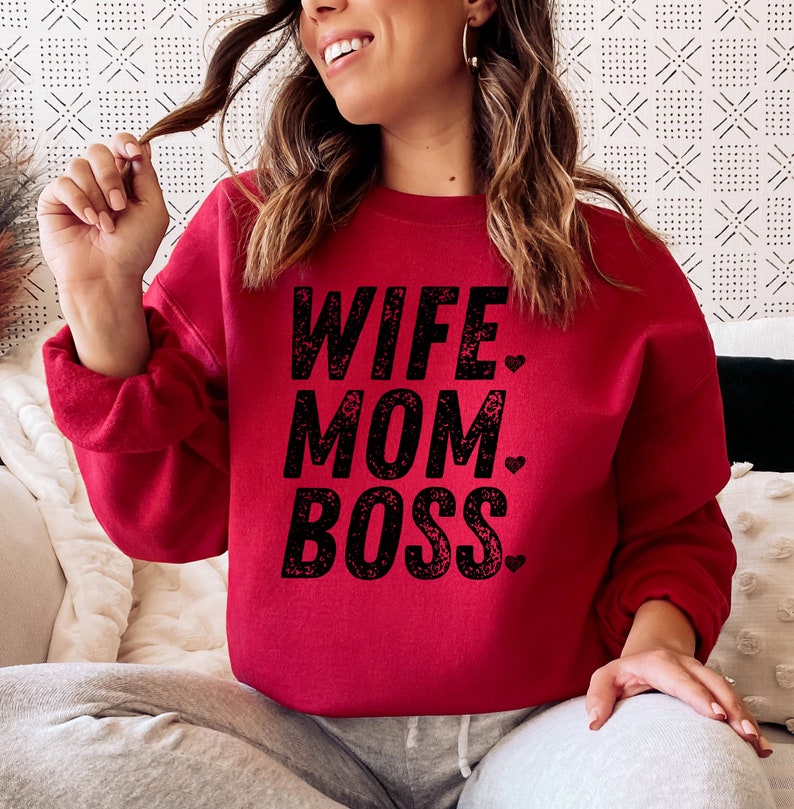 May include: Red sweatshirt with the text "Wife. Mom. Boss." in black with a heart after each word.