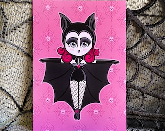 May include: A pink background with a black and white illustration of a bat with a pink and black costume. The bat has a pink face with large eyes and a red mouth. The bat is wearing a black cape with a red heart on the chest. The bat is flying with its wings spread out.