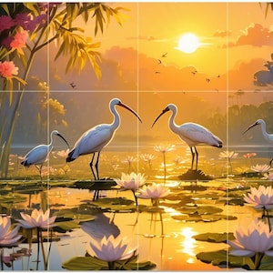 May include: An artistic depiction of a serene wetland scene at sunset. White birds with long beaks stand among lily pads in the water. The sky is a gradient of orange and yellow, with pink flowers and green foliage in the background.