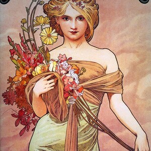 May include: A woman in a green dress and a brown shawl holds a bouquet of flowers. The flowers are a mix of red, pink, yellow, and white. The woman has blonde hair and is wearing a crown of flowers.
