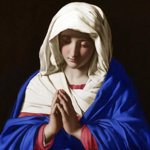 May include: A painting of a woman in a white head covering and a blue robe, with her hands clasped in prayer.