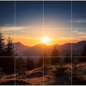 May include: A scenic landscape photograph of a mountain range at sunset. The sun is setting behind the mountains, casting a warm orange glow across the sky. Silhouetted evergreen trees are in the foreground.