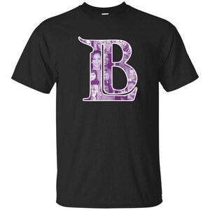 May include: Black t-shirt with a purple letter "B" made up of a collage of photos.