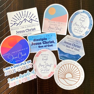 May include: A collection of nine stickers with various designs and colors. Each sticker features a quote from the Book of Mormon, "Behold, I am a disciple of Jesus Christ, 3 Nephi 5:13". The stickers feature different backgrounds, including mountains, sunsets, and water.