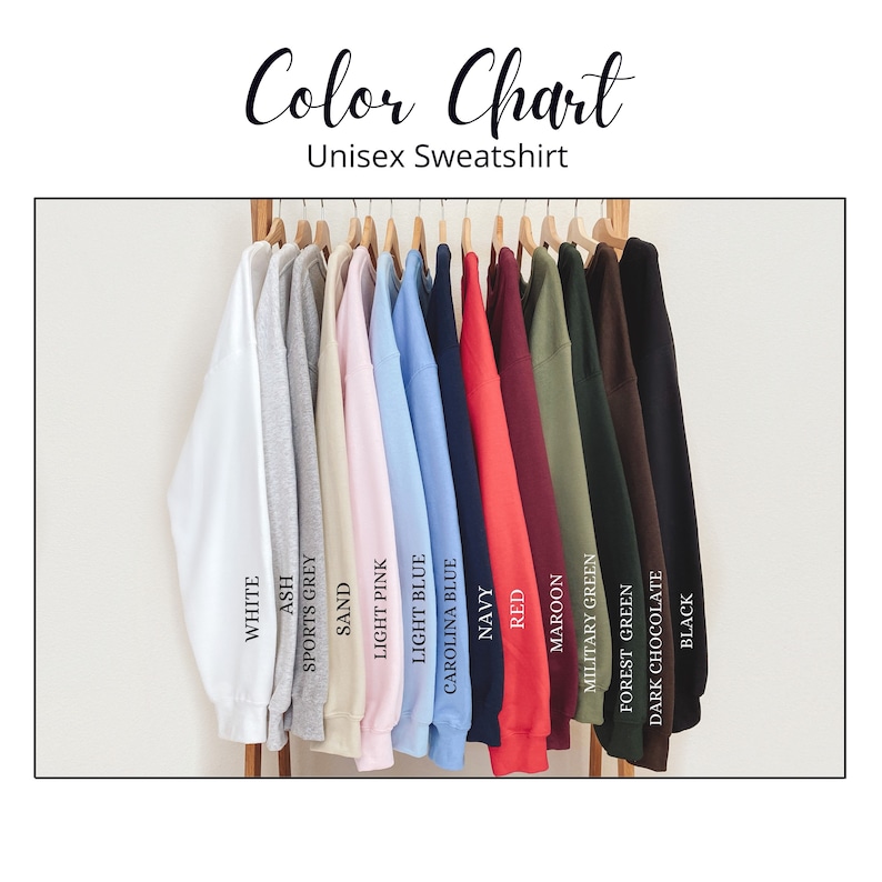 May include: Color chart showing 14 different sweatshirt colors, including white, ash, sports grey, sand, light pink, light blue, Carolina blue, navy, red, maroon, military green, forest green, dark chocolate, and black.