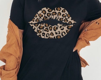 May include: Black t-shirt featuring a large leopard print lips design.