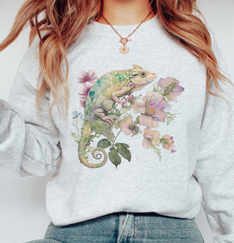 May include: A grey sweatshirt with a green chameleon and pink flowers printed on the front.