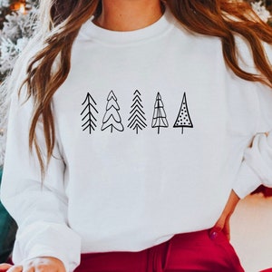 May include: White sweatshirt with a black graphic of five stylized Christmas trees.