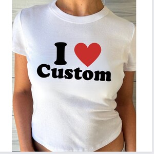 May include: White t-shirt with a black graphic that says "I love Custom" with a red heart.