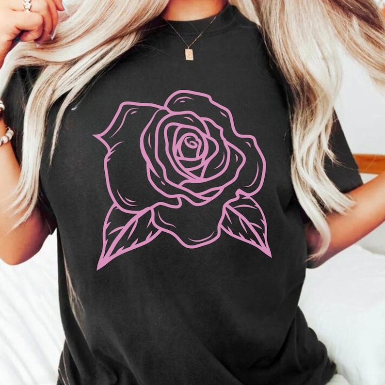 May include: Black t-shirt with a pink outline of a rose.