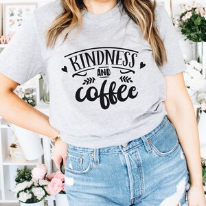 May include: A gray t-shirt with the text "Kindness and coffee" in black lettering with a heart and leaf design.