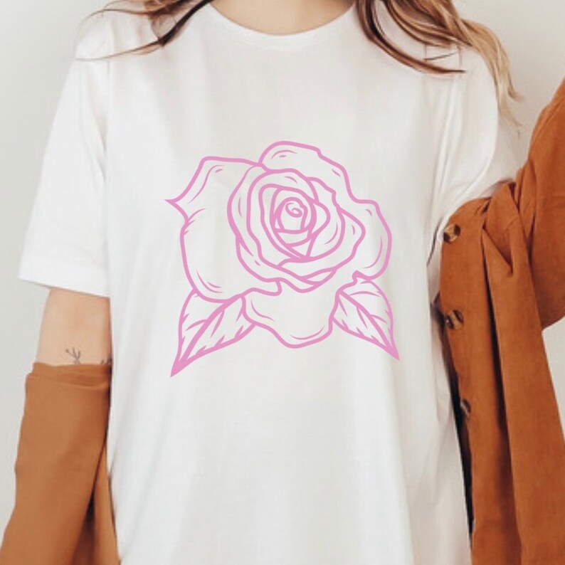 May include: A white t-shirt with a pink outline of a rose.