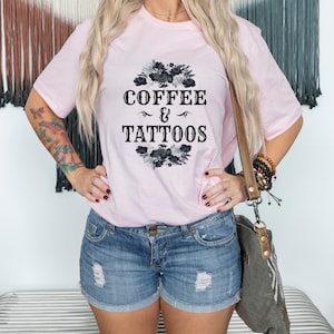 May include: A pink t-shirt with a black floral design and the text "COFFEE & TATTOOS" in a vintage font.