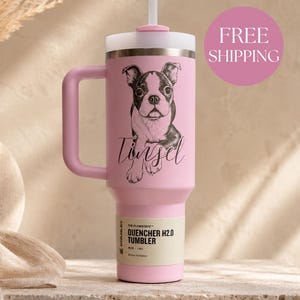 May include: A light pink Stanley Quencher H2.0 tumbler with a handle and a straw. The tumbler features a black and white illustration of a Boston Terrier dog above the name Tinsel in cursive script. The base label reads 40 oz | 1.18 L.