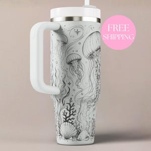 May include: A white stainless steel tumbler with a handle and a straw, featuring a detailed black line art illustration of jellyfish, coral, and seashells. The design wraps around the exterior, showcasing various marine life elements.