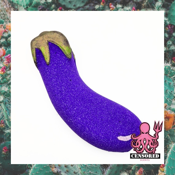 A bath bomb shaped like an eggplant emoji — the naughty joke writes itself and it's actually a usable bath product.