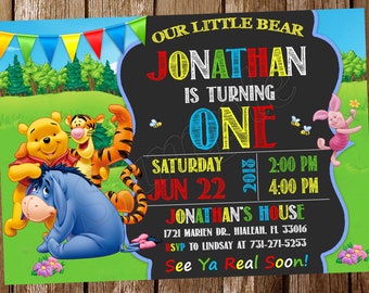 May include: A colorful birthday invitation featuring Winnie the Pooh, Tigger, Eeyore, and Piglet. The invitation reads "Our Little Bear Jonathan is Turning One" with event details including the date, time, and location. The background includes a green field and blue sky.