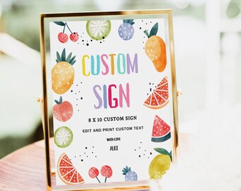 May include: A framed custom sign with colorful fruit illustrations. The sign reads "CUSTOM SIGN" in rainbow colors, with the text "8 X 10 CUSTOM SIGN" and "EDIT AND PRINT CUSTOM TEXT". The sign is in a gold frame.
