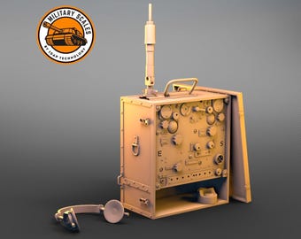 May include: A beige military radio with a long antenna, a headset, and a control panel with knobs and switches. The radio is in a wooden box with a hinged lid. The box has a metal handle and a metal latch.