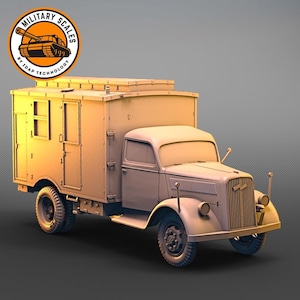 May include: A beige model of a World War II era German Opel Blitz truck with a box body. The truck has a canvas top and a spare tire mounted on the back. The truck is on a gray background.