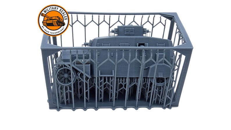 May include: A gray 3D printed model of a tank inside a gray plastic crate. The crate has a lattice design and the tank is partially visible. The tank is a military vehicle with wheels and a turret. The image is labeled "Military Scales by 3Drap Technology".