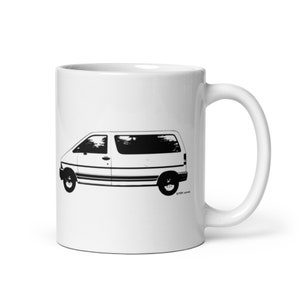 May include: White ceramic mug featuring a black silhouette of a Ford Aerostar minivan.