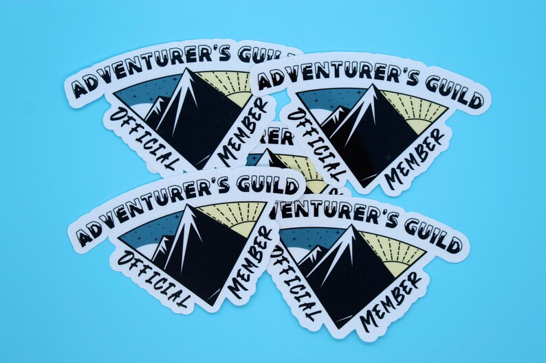 May include: Five white stickers with a black mountain range design and the text "Adventurer's Guild" in a curved white banner. The text "Official Member" is also on each sticker in a curved white banner.