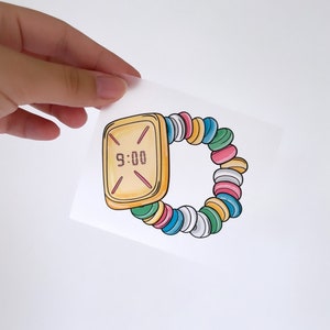 May include: A yellow digital watch with a candy bracelet. The watch face displays 9:00.