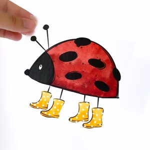 May include: A red ladybug with black spots wearing yellow rain boots with white polka dots.