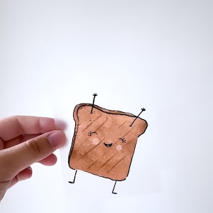 Könnte beinhalten: Eine Cartoon-Illustration eines lächelnden Toastbrots mit Armen und Beinen. Der Toast ist braun und hat ein Gittermuster.