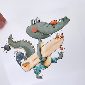 May include: A green alligator wearing blue and white patterned shorts is holding a surfboard. The alligator is smiling and has a red blush on its cheeks. There are several small orange crabs on the surfboard and one black spider on the left side of the image.