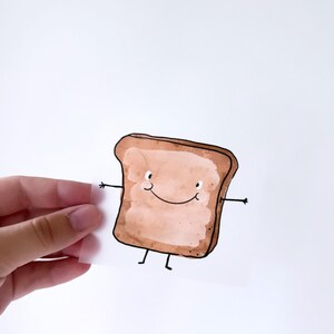 Könnte beinhalten: Eine Cartoon-Illustration eines lächelnden Toastbrots mit Armen und Beinen. Das Toastbrot ist braun und hat ein hellbraunes Inneres. Das Toastbrot ist auf weißem Hintergrund gezeichnet.