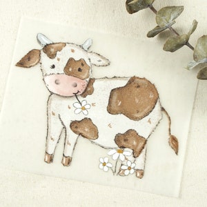 May include: A watercolour illustration of a brown and white cow with a daisy in its mouth. The cow is standing on a white background with three white daisies at its feet.