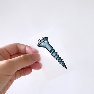 May include: A blue screw with a smiling face drawn on it. The screw has a black outline and white eyes.