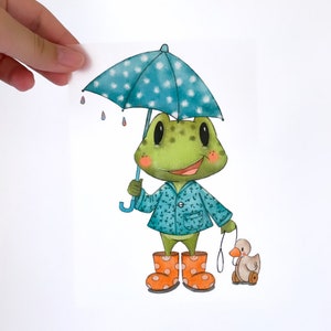May include: A green frog wearing a blue raincoat and orange rain boots holds a blue and white polka dot umbrella and walks a toy duck on wheels.
