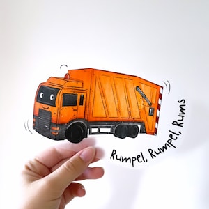 May include: A cartoon illustration of an orange refuse truck with a smiling face. The truck has a black chassis and black wheels. The text "Rumple. Rumple. Rums" is written in black below the truck.